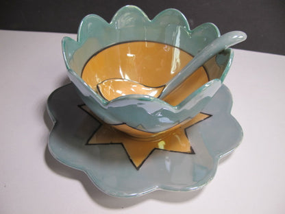 Green and amber bowl with spoon and underplate