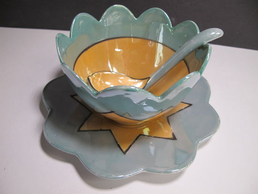 Green and amber bowl with spoon and underplate